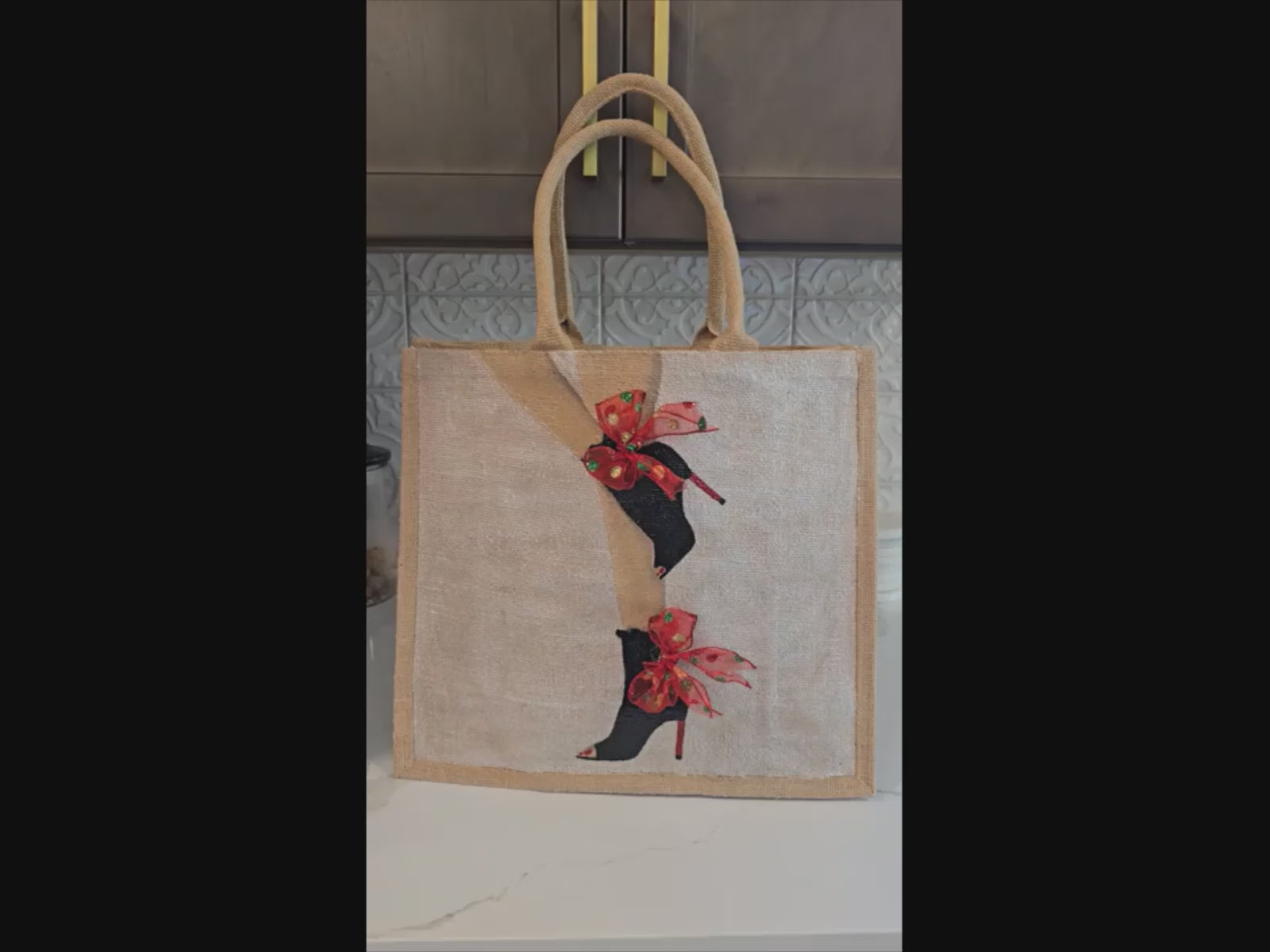 video of Kicking Up Her Heels Tote Bag, woman legs with black booties and red multicolored ribbon