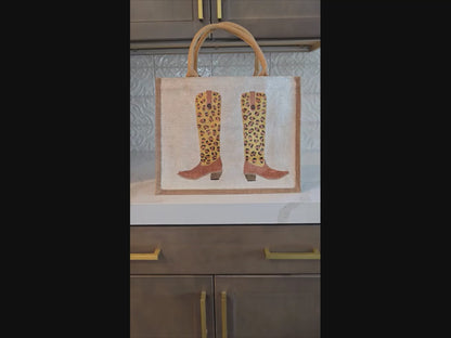 Off white jute tote bag with hand-painted leopard print cowboy boots, detailed with bead accents.