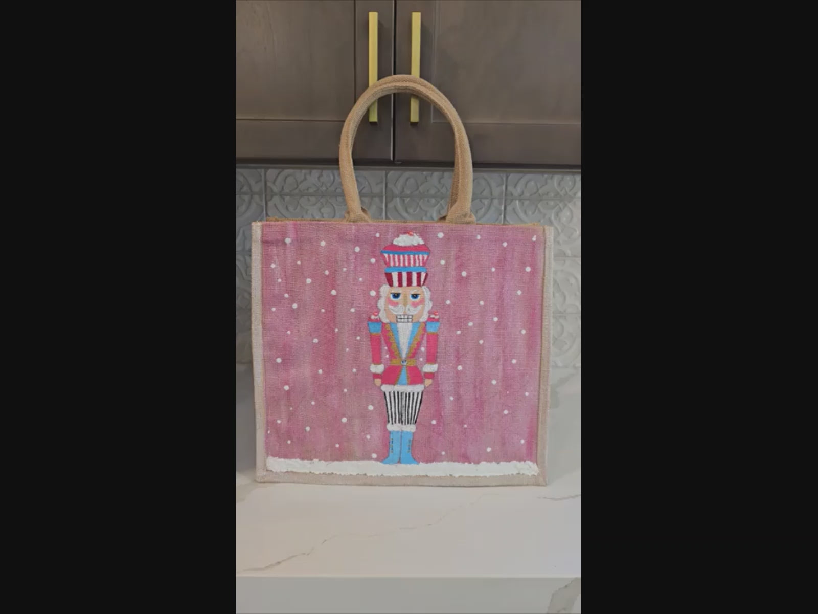 Hand-painted pink Nutcracker on a snowy background, on a jute tote bag.
