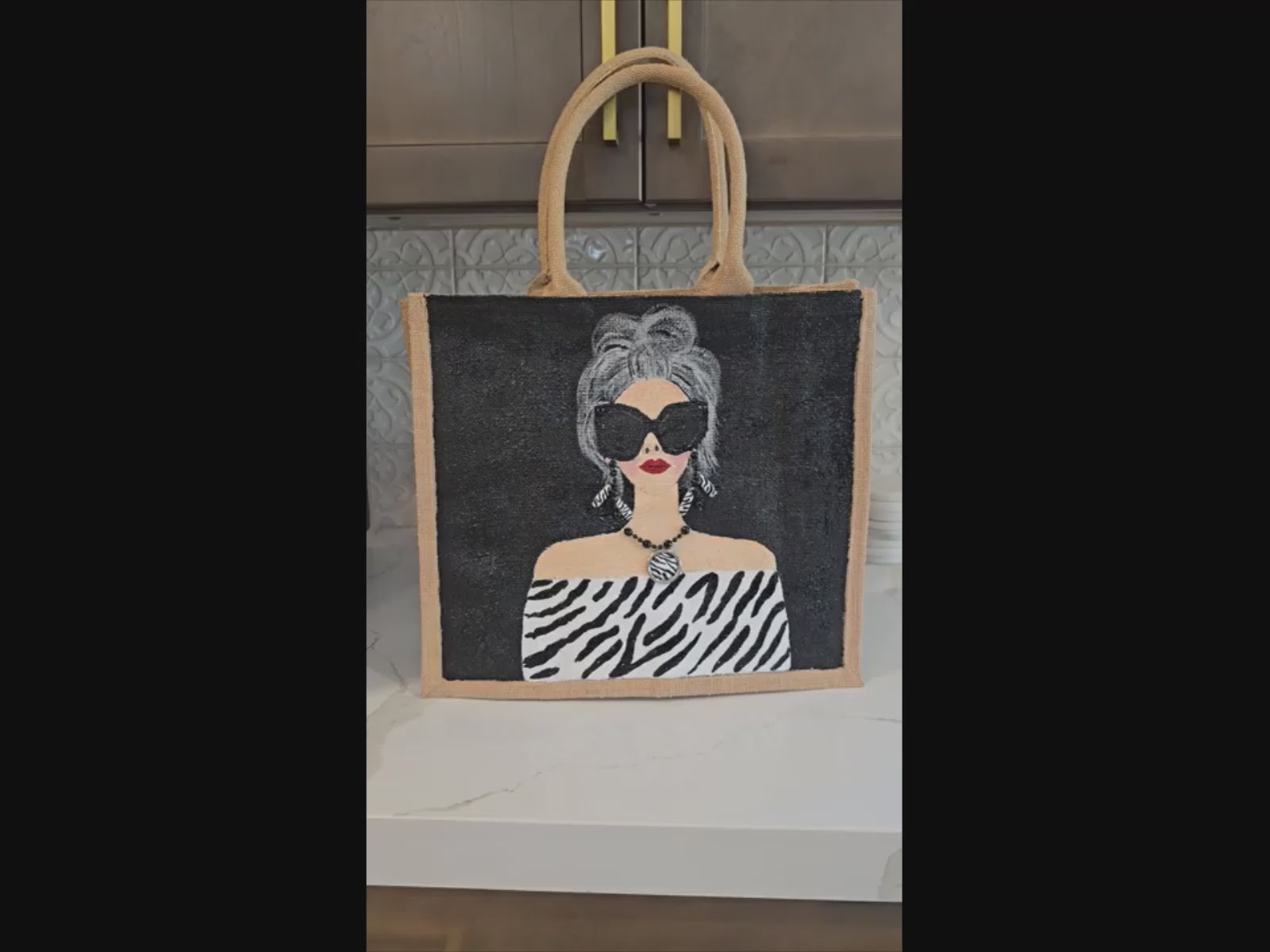 video of Hand-painted black and white fashion tote bag with zebra-inspired outfit and stylish woman illustration on jute tote