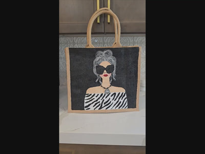 video of Hand-painted black and white fashion tote bag with zebra-inspired outfit and stylish woman illustration on jute tote