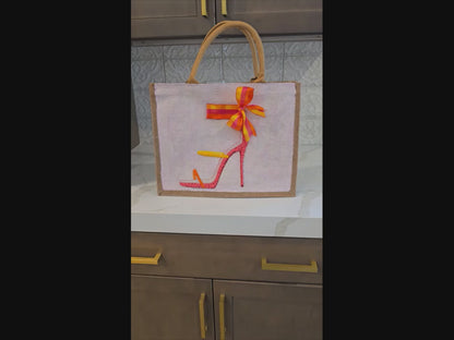 Off white jute tote bag with hand-painted high heel sandals in vibrant colors, accented with bead details.