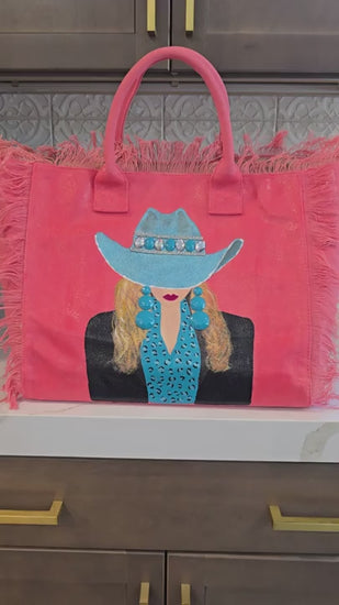 Video showcasing the Turquoise Trails hand-painted Western cowgirl fringed tote bag from multiple angles, highlighting handcrafted embellishments and wearable art details.