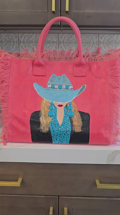 Video showcasing the Turquoise Trails hand-painted Western cowgirl fringed tote bag from multiple angles, highlighting handcrafted embellishments and wearable art details.