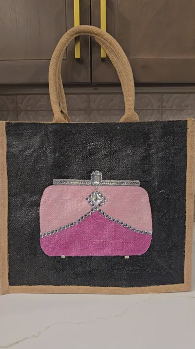 video of Pink jeweled purse design hand-painted on black jute tote bag