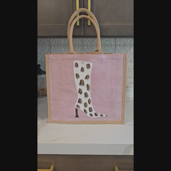 Cow Print Boot Tote Bag.  Brown, black and gold cow print on white boot set on metallic light pink background.