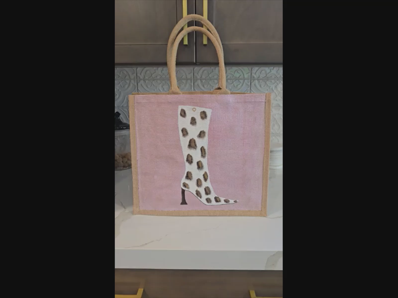 Cow Print Boot Tote Bag.  Brown, black and gold cow print on white boot set on metallic light pink background.
