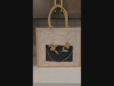 Video of jute tote bag featuring black purse with golden flowers embellished wihth rhinestones and jewels