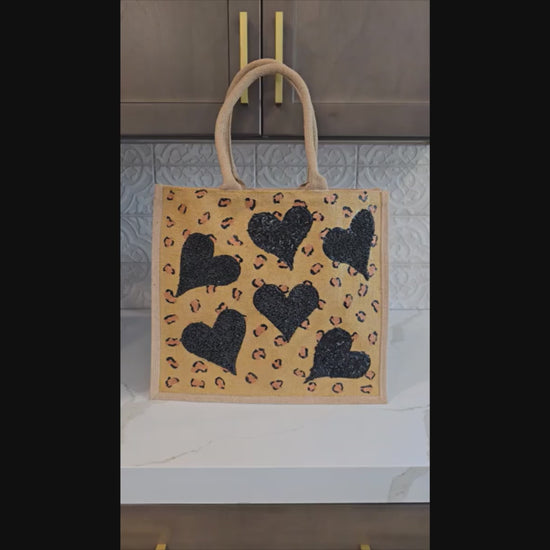 video of Hand Painted and embellished animal print with black beaded hearts tote bag by Dana's Uncommon Glass