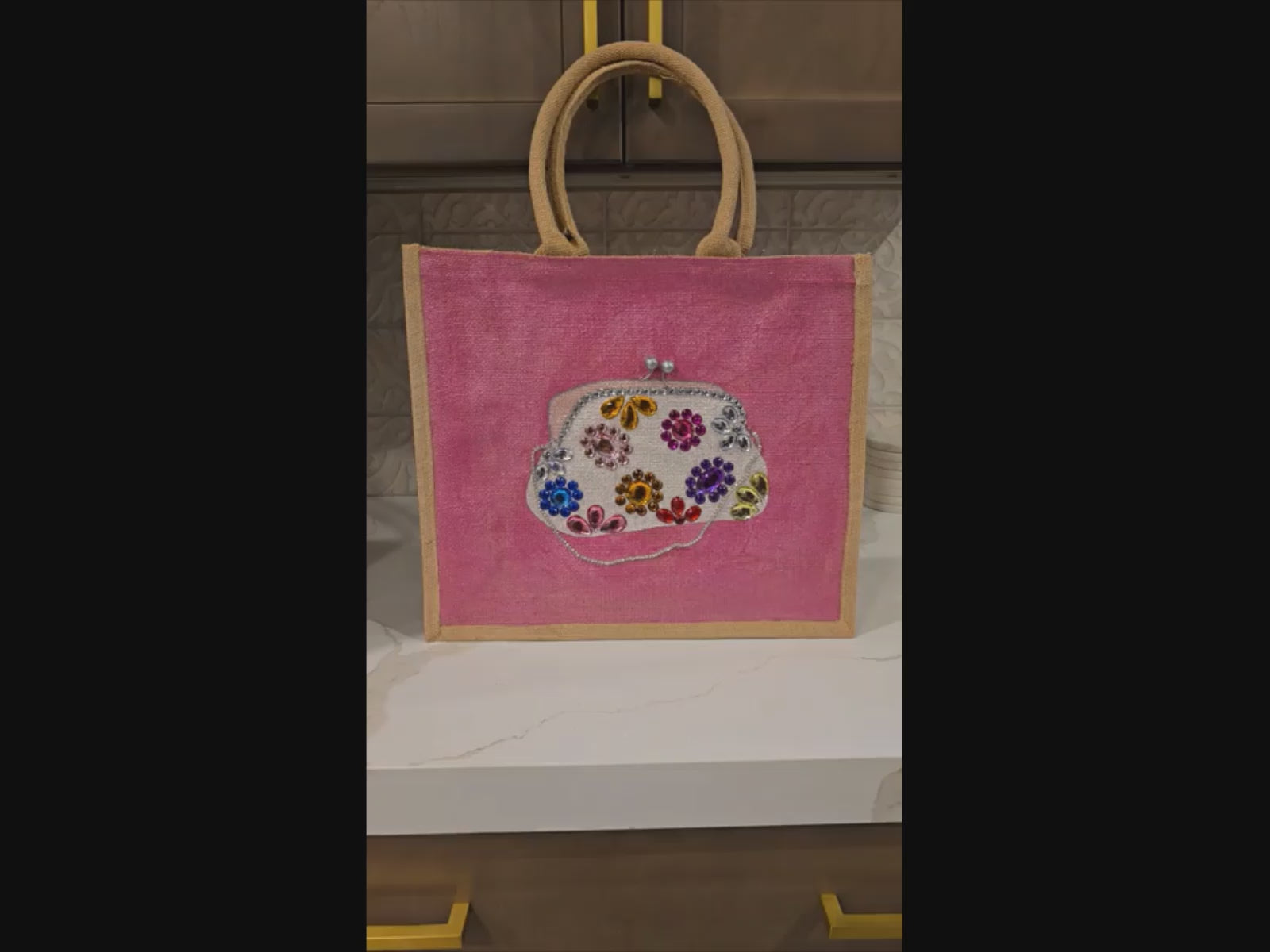 Video of Hand-painted pink jute purse tote featuring jeweled floral embellishments and a structured silhouette