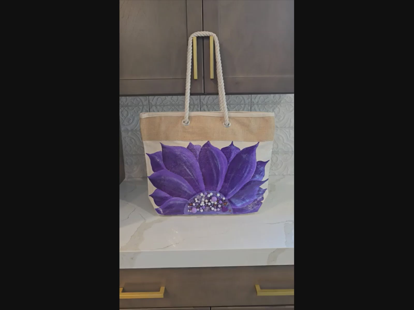Video of Hand-painted rope handle tote bag featuring a vibrant purple sunflower with bead embellishments.