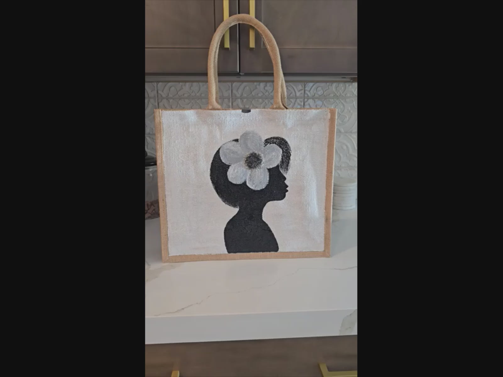video of  Magnolia Muse hand painted tote bag by Danas Uncommon Glass