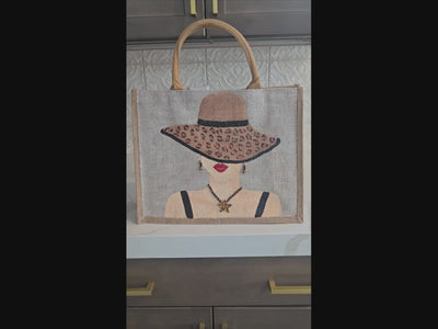 video of animal print tote bag, lady in hat tote bag, beaded animal print jute bag, eco-friendly fashion tote, off white tote bag