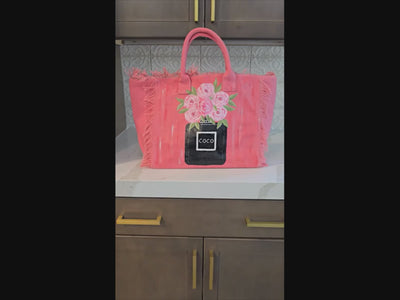 video of coco blooms tote, pink floral tote bag, fringed canvas tote, hand painted flower bag