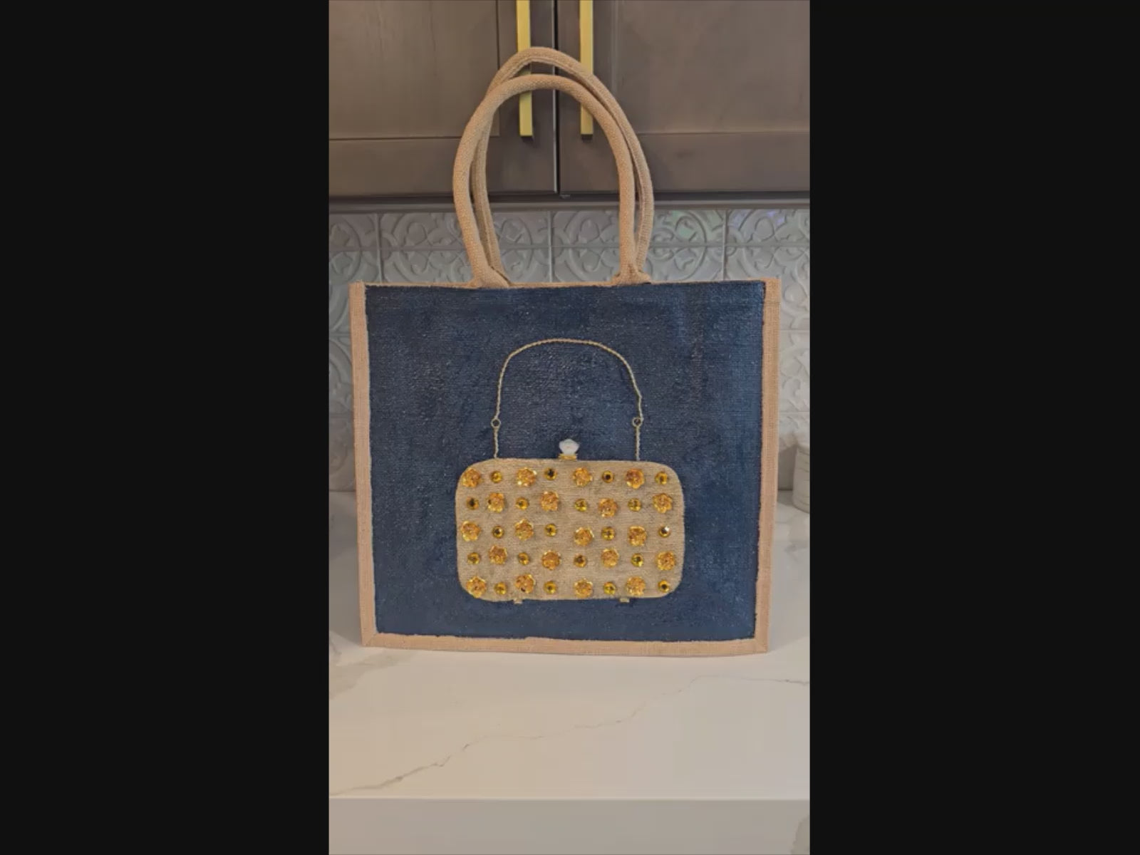 video ofHand-painted navy jute purse tote with gold flower and jewel embellishments 