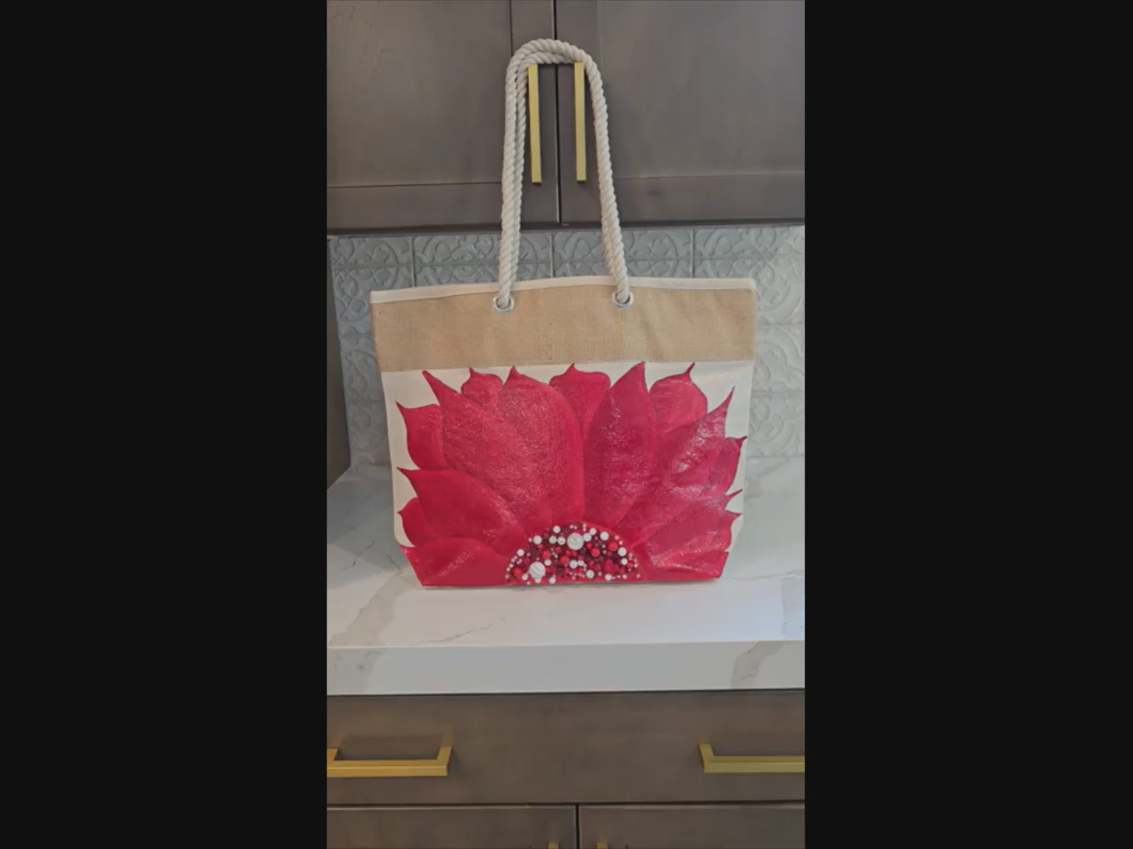 Video of Hand-painted rope handle tote bag featuring a bold red sunflower with bead embellishments.