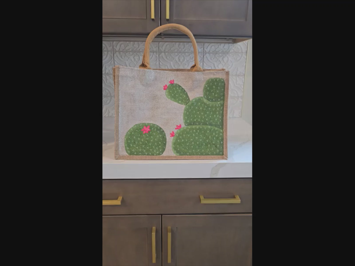 Video of blooming cactus tote bag, off white cactus tote, hand painted cactus jute bag, eco-friendly cactus market bag