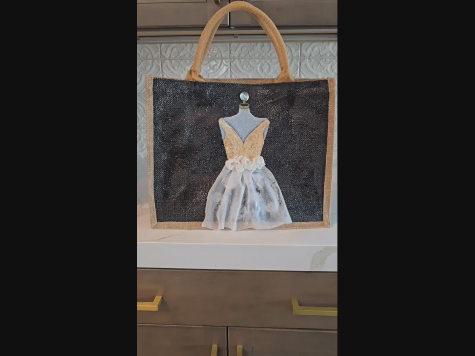 video of Black jute tote bag with hand-painted white wedding dress design and beaded embellishments.