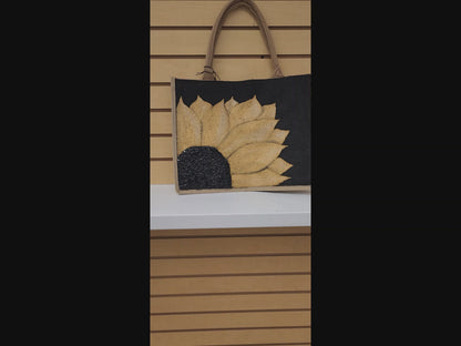 Black jute tote bag with hand-painted gold sunflower and beaded details, designed for bold, cheerful style