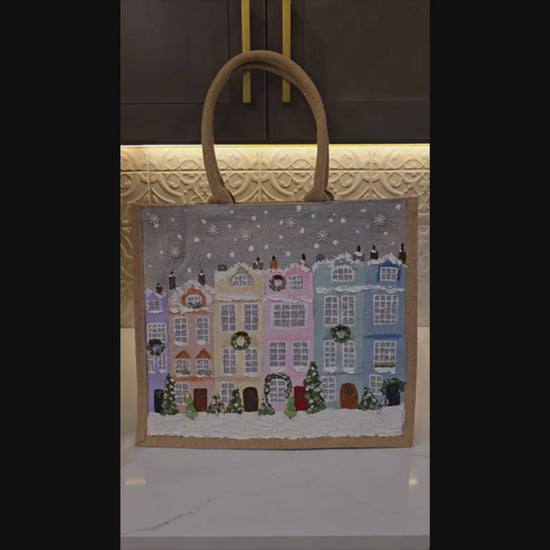 Hand-painted pastel gingerbread row houses in the snow on jute tote, Holiday village street artwork on artisan lined tote, Pastel Christmas houses tote with wreaths and snowfall