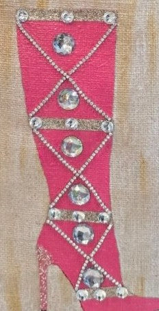 close up of Hand-painted pink jeweled boot tote bag on a natural jute tote featuring sparkling crystal embellishments, a bright pink knee-high boot design, soft neutral background tones, and structured over-the-shoulder handles.