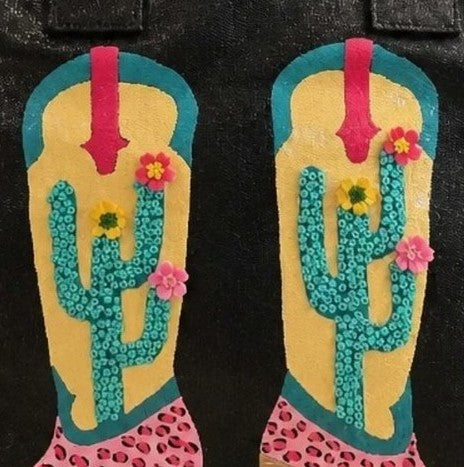 Close-up of the Desert Kicks hand-painted cowboy boots featuring blooming cacti, floral accents, and handcrafted embellishments.