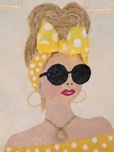 close up of  Sunshine Muse hand-painted fringed canvas tote with blonde woman in yellow polka dots and sunglasses